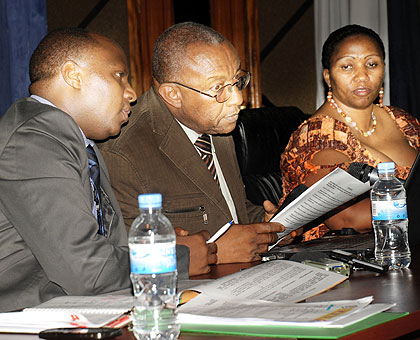 NEC President Kalisa Mbanda (C) consults with Executive Secretary Charles Munyaneza as vice president Marie Odette Kansanga looks on. The New Times/ John Mbanda.