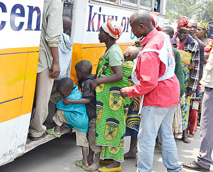 Congolese refugees board a bus to Mugunga camp during their repatriation yesterday. The New Times/ Jean Mbonyinshuti.