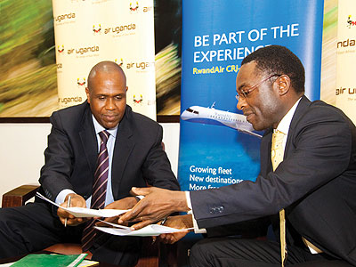 Mirenge (left) and Muleya exchange the agreement documents.  The New Times/Timothy Kisambira