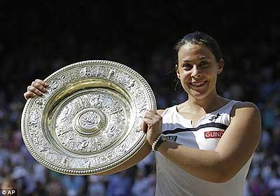 Bartoli with the Venus Rosewater Dish after winning Wimbledon this year. Net photo.