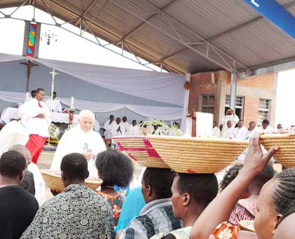 The faithful carry their offerings on Assumption Day at Kibeho Mary Mother of the Word in Nyaruguru District yesterday. Thousands of Catholic faithful from across the world flocked Kib....