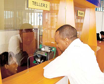 A customer seeks service from a micro-finance institution. The New Times/ File.