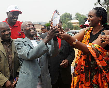 Minister Kalibata (R) awards members of CAFERWA Shangi who emerged overall winners of this yearu2019s coffee Cup of Excellency yesterday.  Saturday Times/John Mbanda