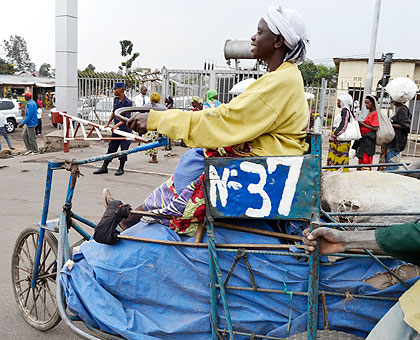Emerthe Nyirabagenzi on her tricycle at the Rwanda-DR Congo border. The wheelchair is specially built to carry luggage.  The New Times/ Jean du2019Amour Mbonyinshuti.