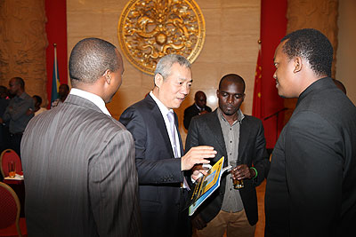 Ambassador Shen interacts with some of the former beneficiaries of the Chinese government  scholarships.  The New Times/Ivan Ngoboka.  