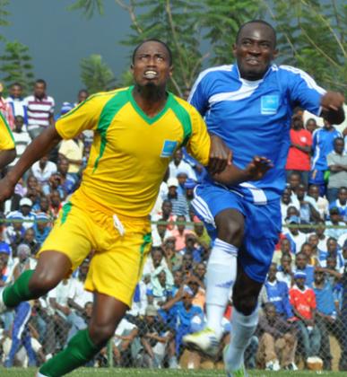 AS Kigali striker Eric Serugaba (left) battles Rayon Sports's Amiss Cedric during the Super Cup match on Sunday. Times Sport / P. Muzogeye