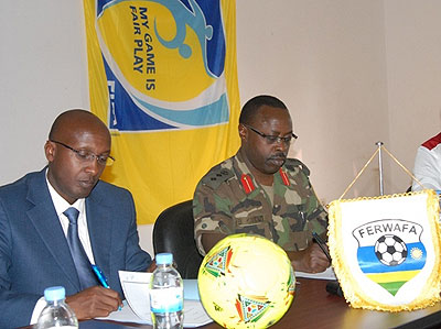 Ferwafa chairman  Ntagungira and Head of Kanombe Military Hospital Col Dr Ben Karenzi signing the pact on Wednesday. Times Sport/Courtesy.