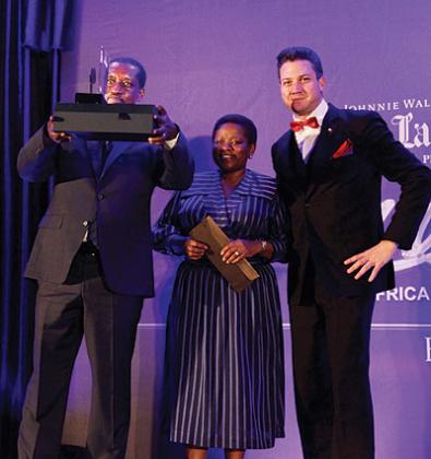Gatera displays the AABLA (East Africa) award. Other three people also won in various categories. The New Times / John Mbanda