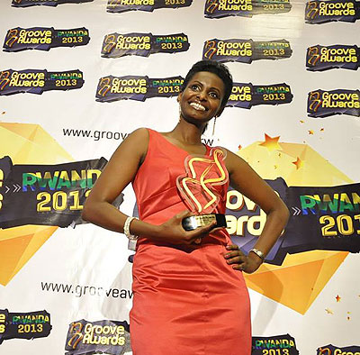 Gabby Kamanzi poses with a trophy during the launch of Groove Awards Rwanda chapter. The New Times / Susan Babijja.