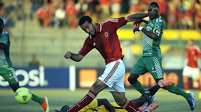 AC Leopards Goalkeeper Lawrence Ngome Ngoe (bottom) tries to defend against Egypt's Al-Ahly player Mohammed Abu Trika (C) during the first leg match. Net photo.