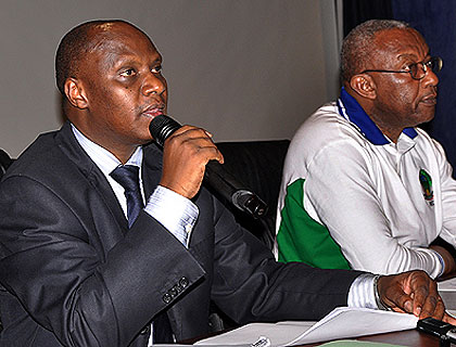 NEC Executive Secretary Charles Munyaneza (L) and Chairperson Prof. Kalisa Mbanda announce preliminary results from Monday's parliamentary polls at the commission headquarters in Kimihurura, yesterday. The New Times/John Mbanda.