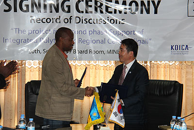 Nsengiyumva (L) andSang-chul Kim after signing the deal.   The New Times/ Timothy Kisambira.