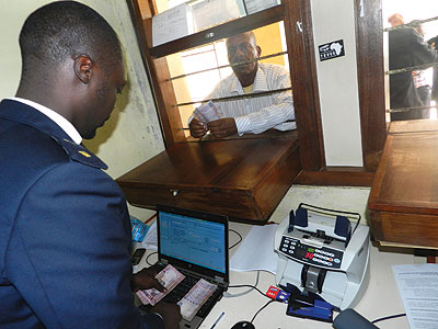A businessman pays tax at Rusumo customs point. Rwanda has made it easy for businesses to pay taxes compared to its regional peers. The New Times / File