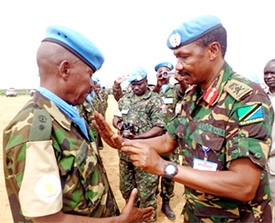 An RDF peacekeeper (L) is decorated during the ceremony on Saturday. The New Times/ Courtesy.