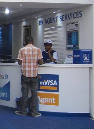 A customer being served at a Bank of Kigali mVisa agency. mVisa helps rural areas to access financial services. The New Times / Ben Gasore