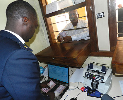 A businessman pays taxes at Rusumo Border Post. Traders will save about $45m annually from reduced clearance costs, The New Times/ John Mbanda.