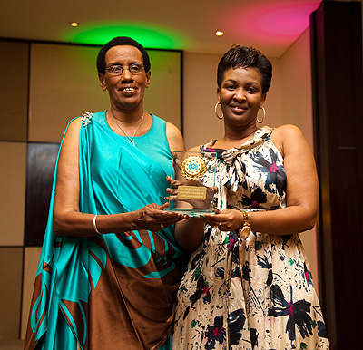 (L-R) Maria Yohana receives the award for best traditional folk diva from Apostle Alice Mignonne Kabera. At the same event, Apostle Kabera was recognised as society role model.
