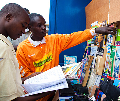                        Bazambaza attends to a client in his bookstore at Nyabugogo. Despite low reading culture, he managed to pick up a trade in selling used books, mainly of lang....