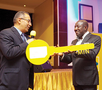 Former MTN boss Khaled Mikkawi hands over the key to his successor Ebenezer Asante, as a sign to mark the end of his management. The New Times / T.Kisambira.