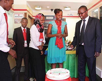 UAE Exchange Rwanda employees and guests cut a cake as the firm launches customer service week. The New Times / Courtesy photo