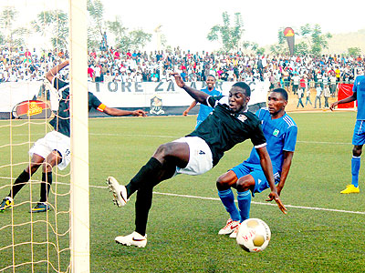 APR defender clears a ball past Espu00e9rance striker last weekend in the second match of the Turbo King Football League. The New Times/Courtesy