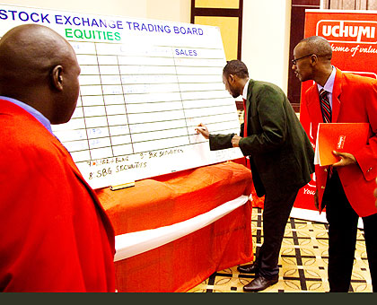 A broker updates a stock trading board in Kigali yesterday. The New Times/  T. Kisambira.