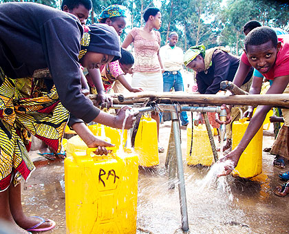 City dwellers draw water from a public source. The New Times/ Timothy Kisambira.