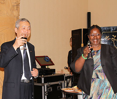 The Chinese ambassador to Rwanda Shen Yong-Xiang and Health Minister Binagwaho toast to the Rwanda-China cooperation on Monday. The New Times/Susan Babijja