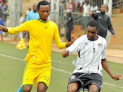 AS Kigali striker Justin Mico battles APR full back Albert Ngabo during yesterday's Turbo King League match at Stade de Kigali. Sunday Sport/P. Muzogeye