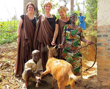 Henriette Uwineza receives a goat from the leaders of Young People for Africa. Sunday Times/Susan Babijja