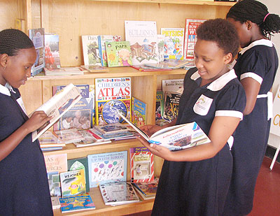 Pupils of Alpha Community Academy check out reading material in their library. The New Times/ Courtesy.