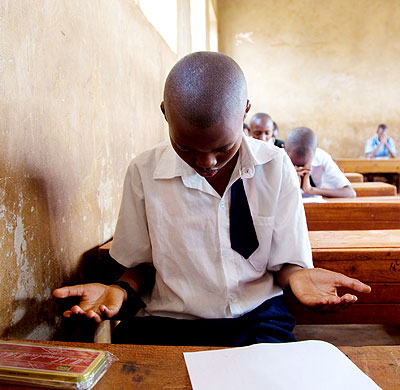 PRAYER FIRST: A pupil prays in the examinations room before the start of the exams.