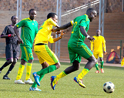 Marines skipper Bonaventure Hategikimana shields the ball past AS Kigali striker Justin Mico. AS Kigali won 1-0 yesterday at Stade de Kigali. The New Times/ Courtesy.