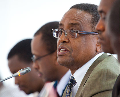 Silas Lwakabamba, the Minister for Infrastructure (R).  On his right is EWSA Director General Ntare Karitanyi.  