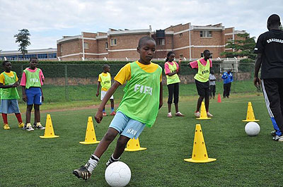 Some of the kids who will take part in the week-long tournament, being taken through their paces at Ferwafa turf in Remera recently. Saturday Sport / Courtesy.