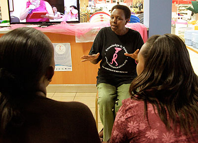 Constance Mukankusi, a counsellor with Breast Cancer Initiative, talks to mothers before the screening last Thursday. The New Times / John Mbanda. 