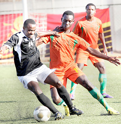 APR's Michel Ndahinduka attempts to dribble past Gicumbi's defender Vincent Habamahoro in yesterday's Turbo King Football League. Times Sport / J. Mbanda.
