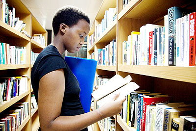 A holidaymaker checks out books in the library. The New Times/ File.