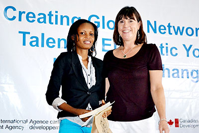 President and CEO of DOT, Janet Longmore (R) congratulates one of the best performers. The New Times/ Courtesy.