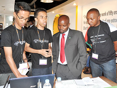 Youth and ICT minister Jean-Philbert Nsengimana is briefed by a participant at ICT4AG. The New Times/Collins Mwai