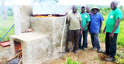 Officials at the demo of the new environmentally-friendly charcoal burning method. The New Times/ Courtesy.