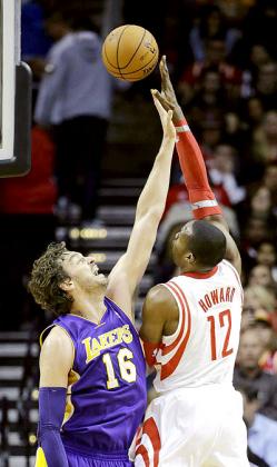 Houston Rocket's Dwight Howard, right, shoots over Los Ageles Lakers' Pau Gasol during the first quarter. Net photo