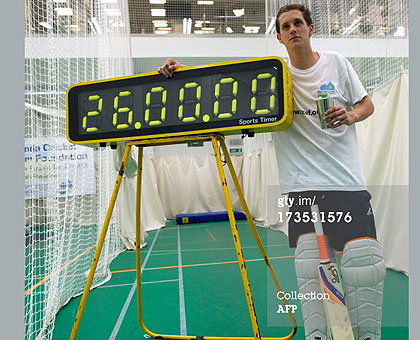 Alby Shale poses next to an electronic timer after batting for 26 hours at the Oval cricket club in London, on July 16. Inset: Alby Shale with his Guiness Book of Records certificate. Saturday Sport / Courtesy.