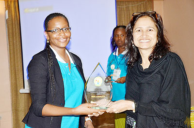 Dr Muhimpundu receives an award at a past conference. The New Times/ Courtesy.