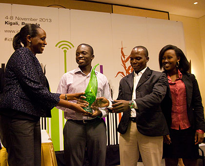 Minister Kalibata (L) awards the winning team, Ensibuuko from Uganda.  The New Times/Timothy Kisambira. 