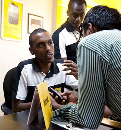 An MTN worker attends to a customer. Most rural people donu2019t have phones. The New Times / T. Kisambira
