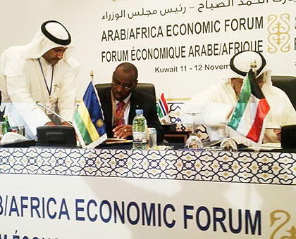 Amb. Gatete (C) and al-Bader sign (R) sign the health funding deal in Kuwaiti City, Kuwait, yesterday.    The New Times/ Courtesy.