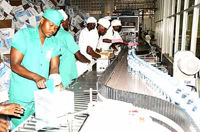 Workers sealing goods at the Inyange Industry.  The New Times/ File.