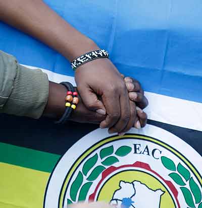 Hands of two East African people in a sign of integration. The New Times/  Timothy Kisambira.