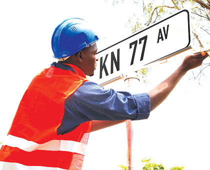 A City of Kigali engineer fixes a street name in Nyarugenge District during the naming exercise in March.    The New Times/ File.
